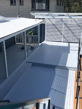 The same deck and alfresco area repainted in a clean modern grey
