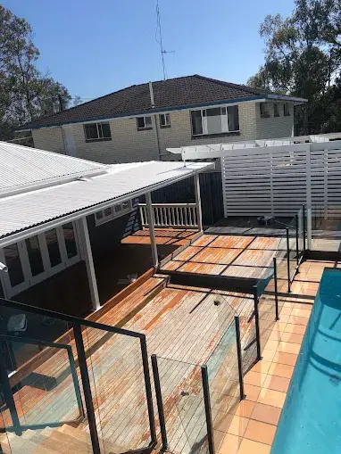 Weathered bare timber deck and alfresco area before repainting