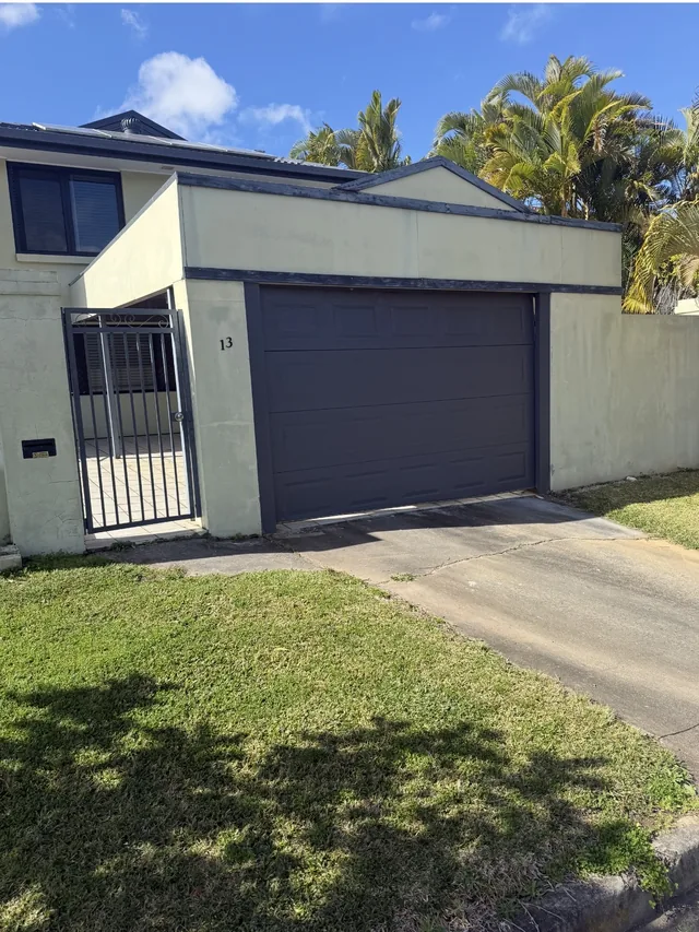 Two storey render and weatherboard home with tired exterior paint, before repainting